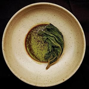 Pumpkin Leaf. Pickled 2 Months And Preserved In A 5% Brine. Now Stuffed With Hokkaido And Szechuan. Served With Tarragon And Freshly Pressed Pumpkin Seed Oil. - Bistro Flores - 532093